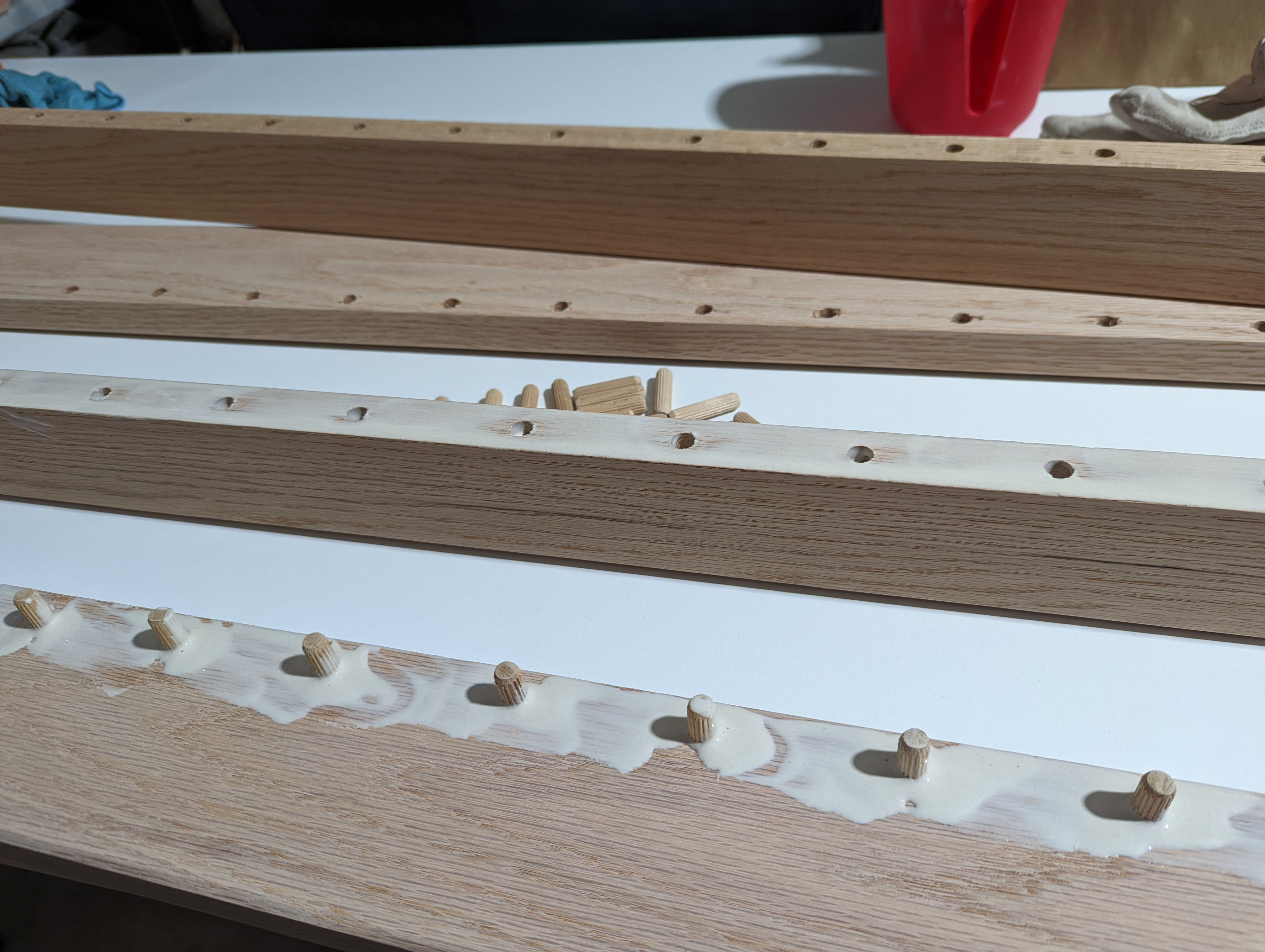 My gluing strategy was to first pour glue into the holes, insert the dowels, then pour glue around them and smear it a bit, and then glue to other board and join them before clamping. It wasn't particularly elegant, but it worked.