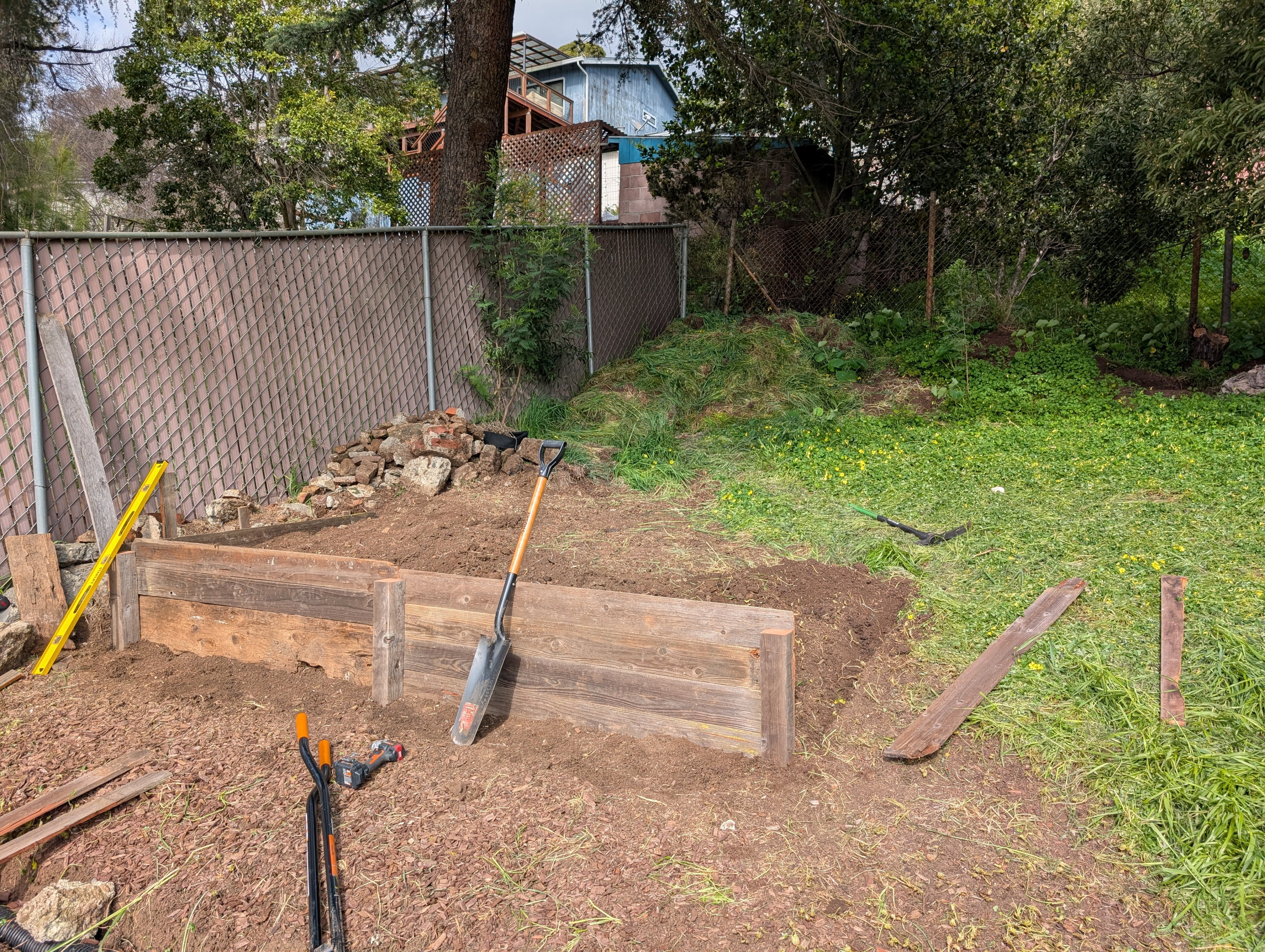 Raised garden bed build in progress.