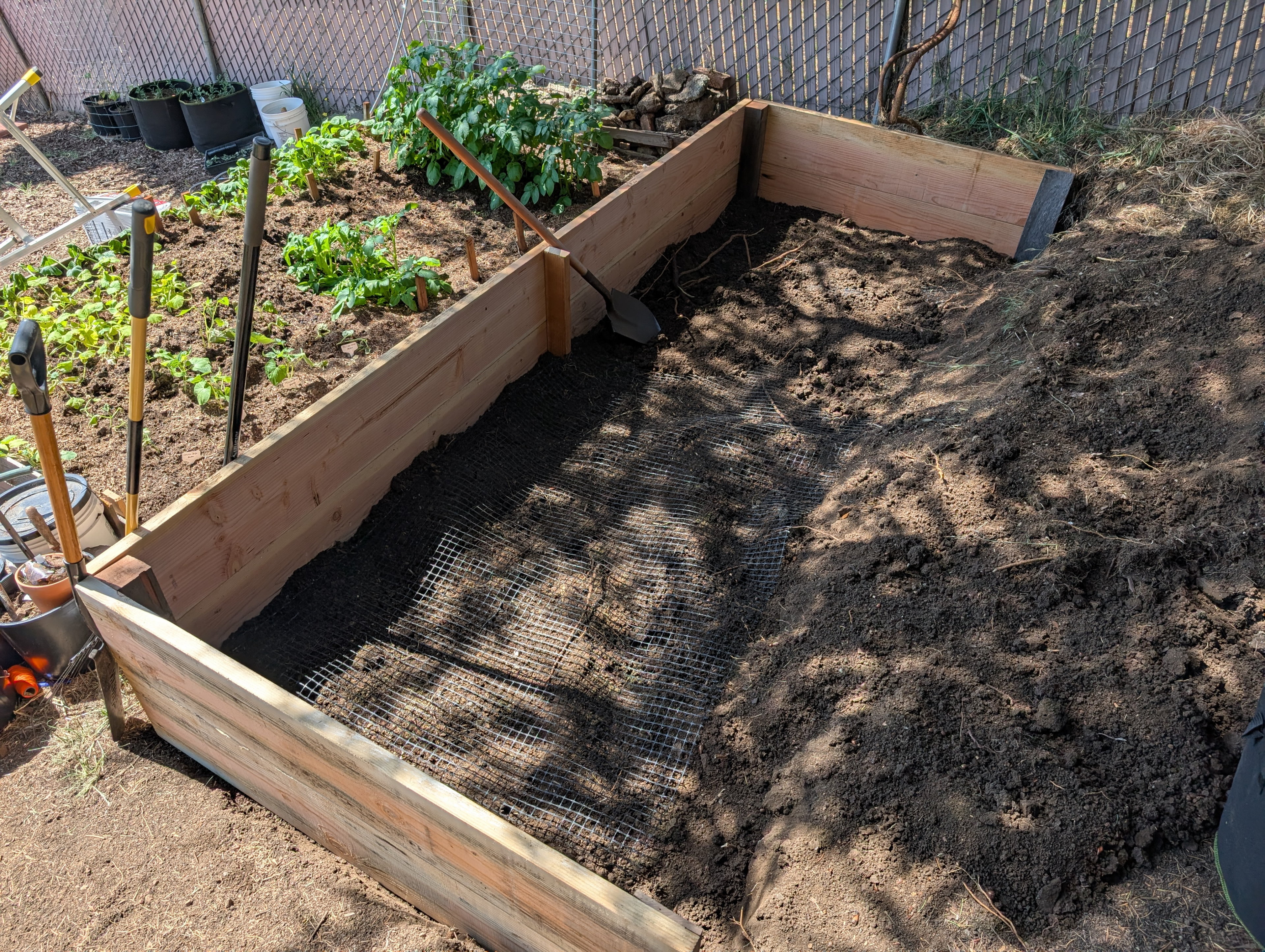 I'm using geotextile out of an abundance of caution so the 12 x 6 x 2 feet of soil doesn't push forward down the hill too much and tip the whole thing over.