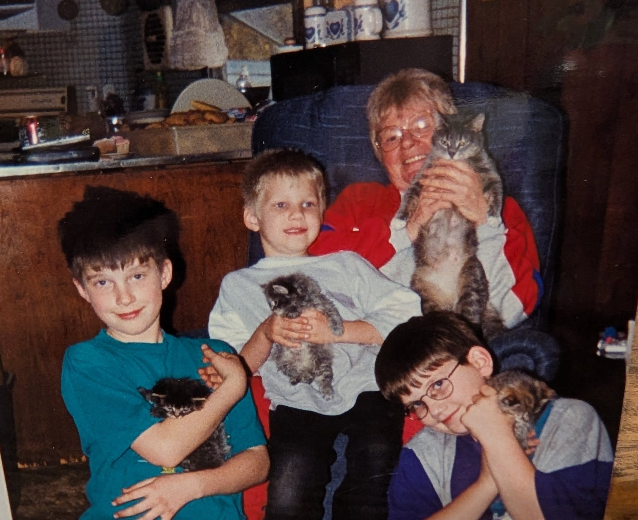 Grandma Porath with me and my brothers Ben and Tim and the cats, two of which we brought home, in the mid 1990s.