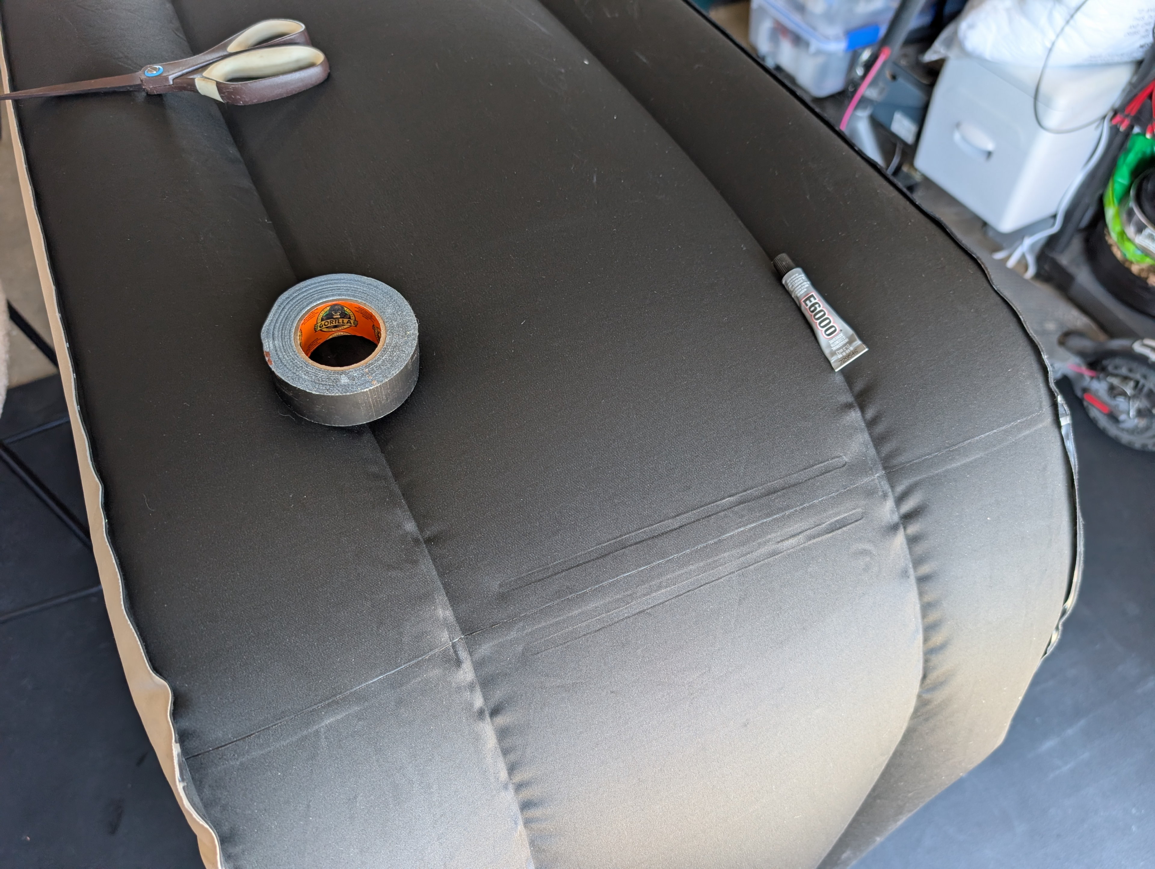 Repairing the air mattress with glue and tape.